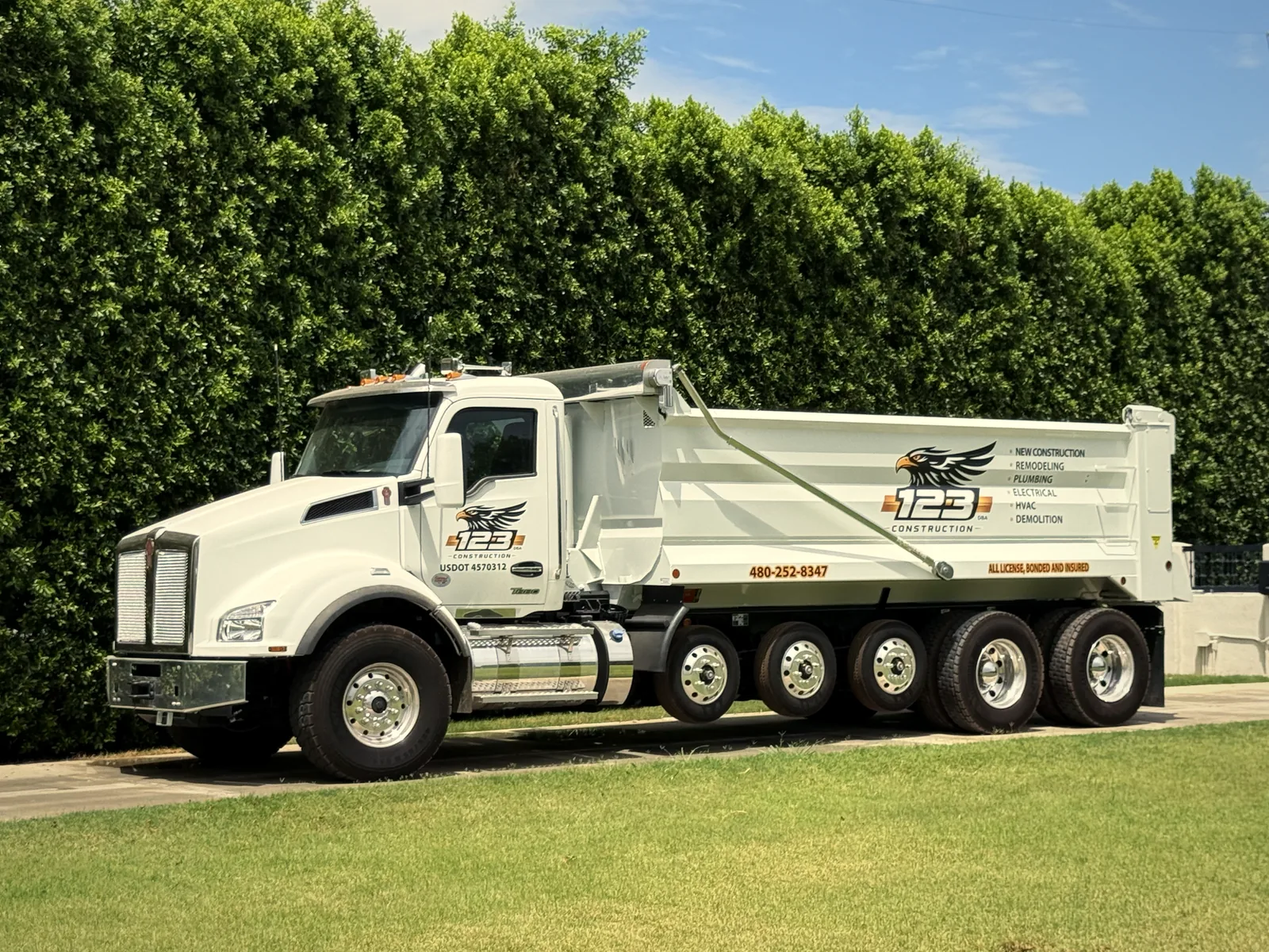 123 Construction DOT-registered dump truck on a Phoenix job site